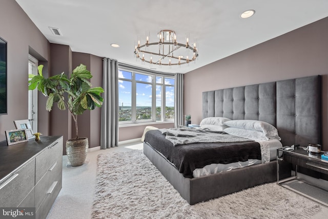 carpeted bedroom featuring a chandelier