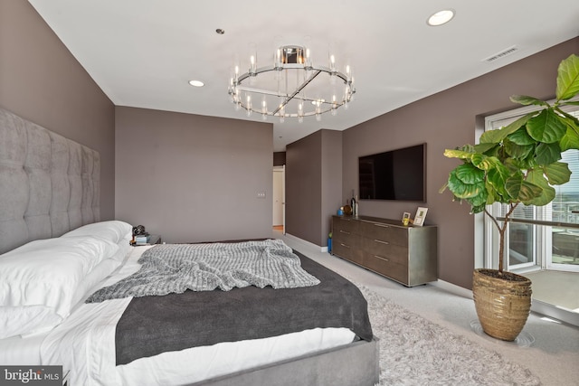 carpeted bedroom featuring an inviting chandelier