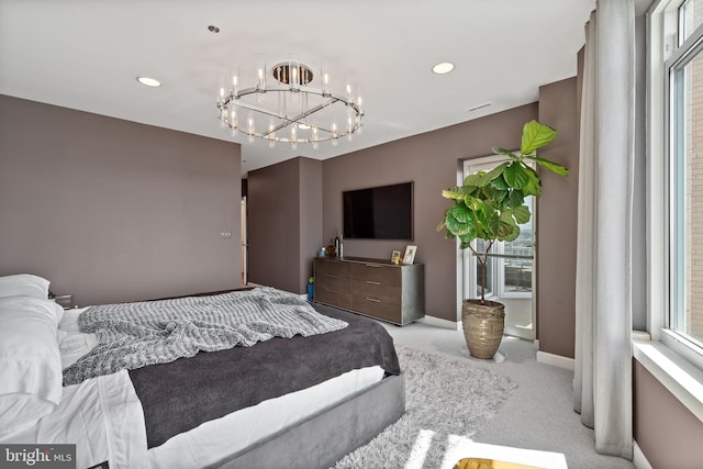 bedroom featuring light colored carpet and a notable chandelier