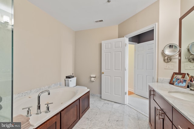 bathroom with vanity and a tub