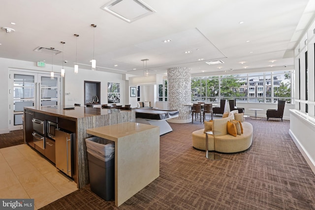 kitchen with a large island with sink and pendant lighting