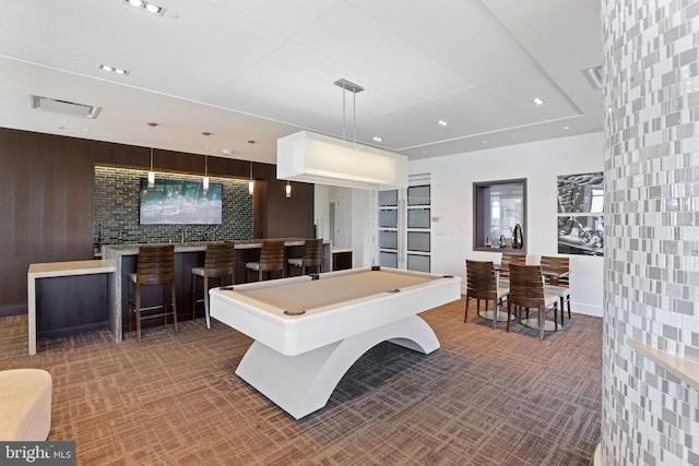 recreation room with indoor bar, pool table, and wood walls