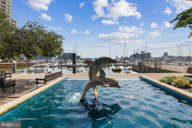 surrounding community with a water view and a boat dock