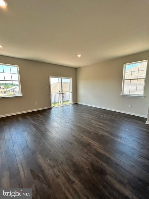 spare room with dark hardwood / wood-style flooring