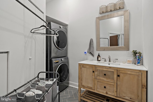 bathroom featuring stacked washer / dryer and vanity