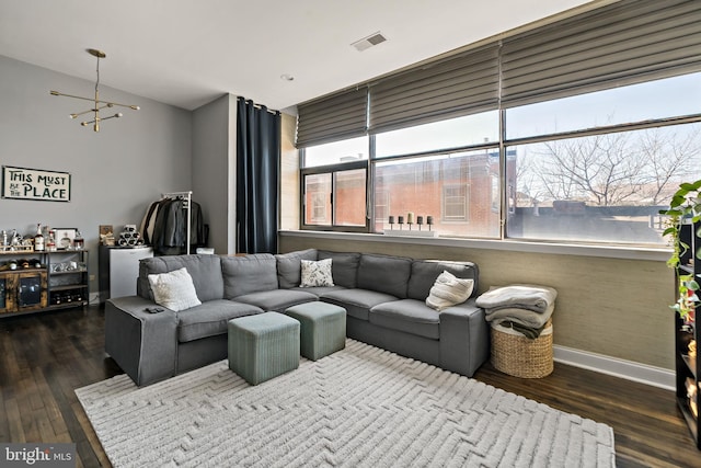 living area with dark wood-style flooring, visible vents, and baseboards