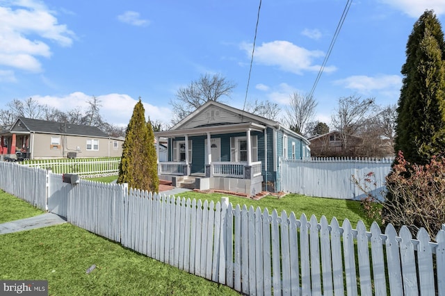 bungalow-style house featuring a porch and a front yard