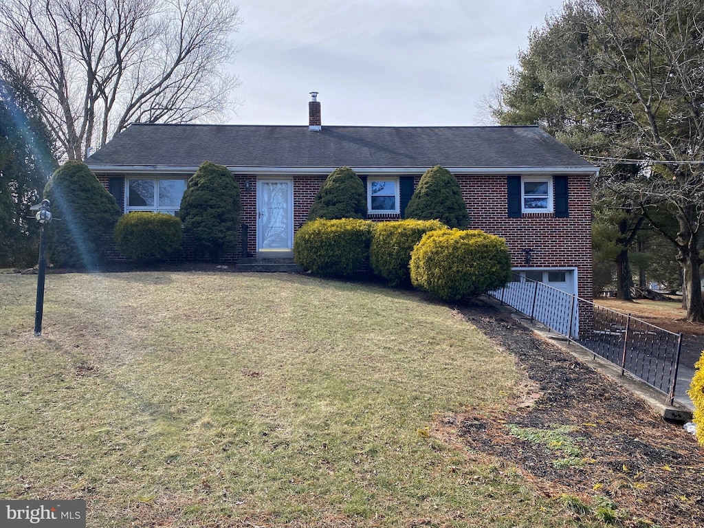 single story home with a garage and a front lawn