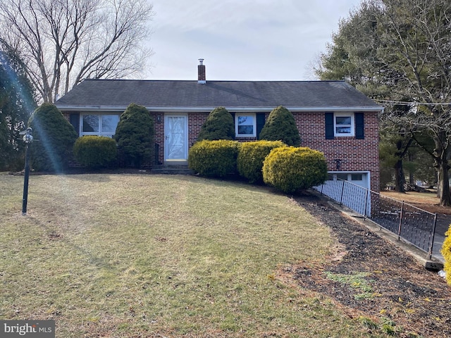 single story home with a garage and a front lawn