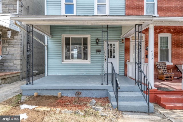 view of exterior entry featuring a porch