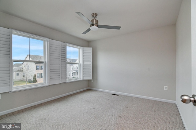 unfurnished room with ceiling fan and light colored carpet