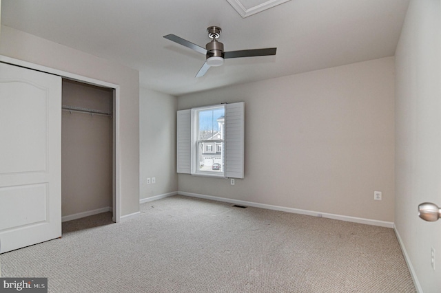 unfurnished bedroom featuring light carpet, ceiling fan, and a closet