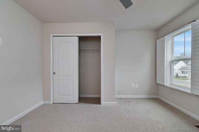 unfurnished bedroom with light carpet and a closet