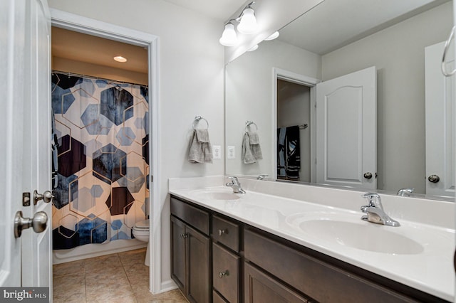 bathroom with vanity, tile patterned floors, and toilet