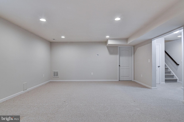 basement featuring light colored carpet