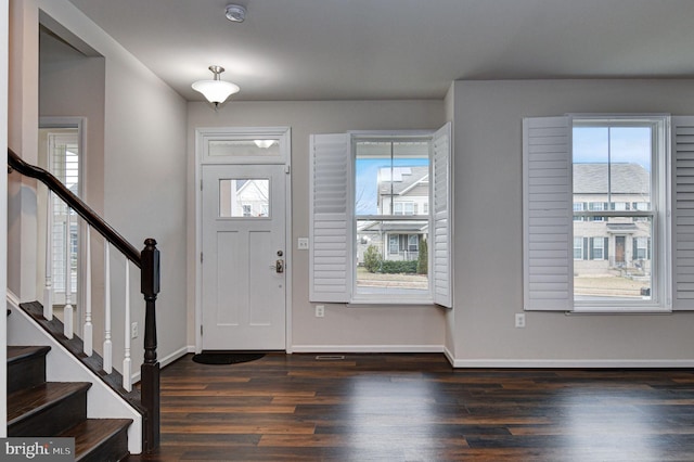 foyer entrance featuring plenty of natural light and dark hardwood / wood-style floors