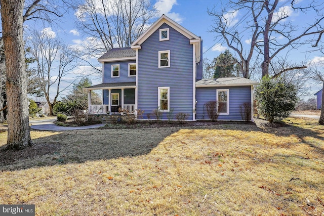 view of front of home featuring covered porch and a front lawn