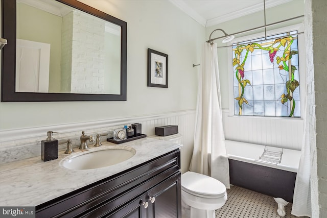 bathroom with a wainscoted wall, ornamental molding, vanity, and toilet