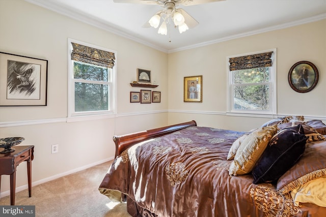 carpeted bedroom featuring a ceiling fan, crown molding, and baseboards