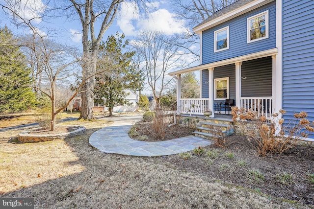 view of yard with covered porch