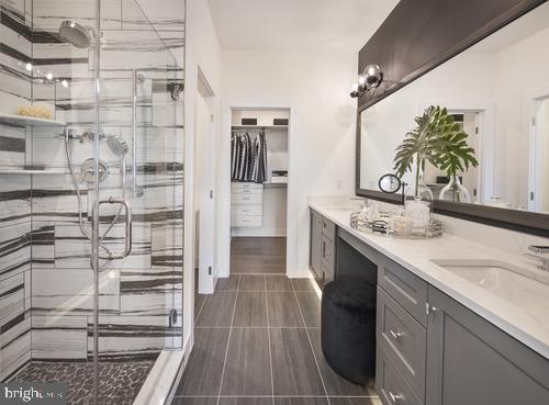 bathroom featuring vanity and an enclosed shower