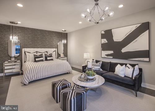 bedroom with an inviting chandelier and wood-type flooring