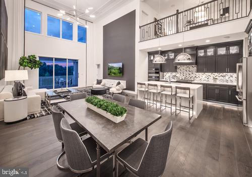 dining space featuring dark wood-type flooring and an inviting chandelier