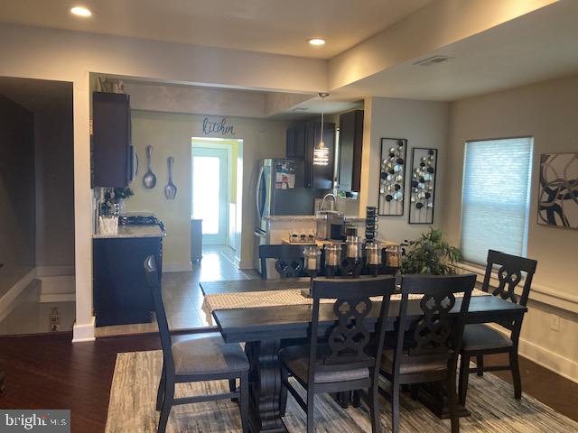 dining room with dark wood-type flooring