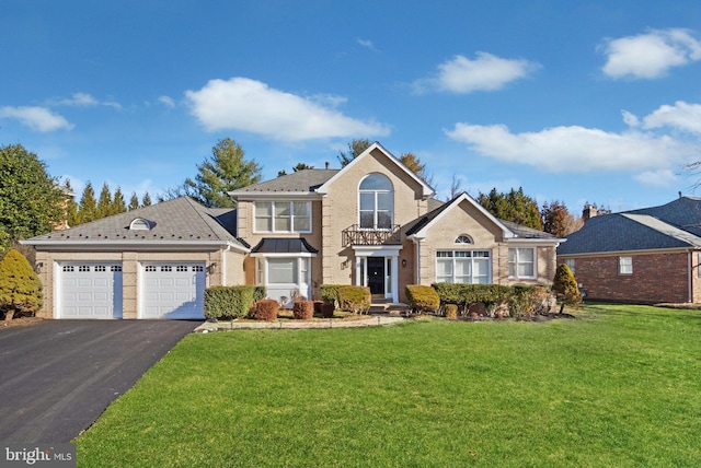 view of property with a garage and a front lawn