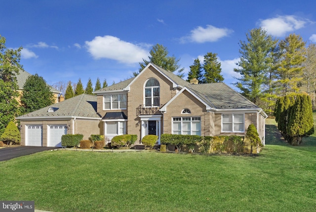 front facade featuring a garage and a front lawn