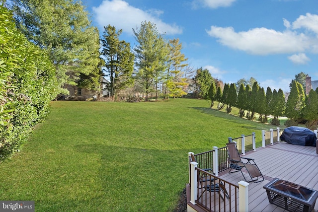 view of yard featuring a fire pit and a deck