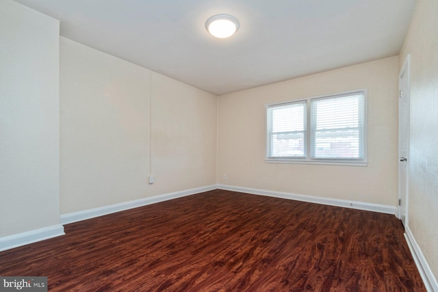 unfurnished room with dark hardwood / wood-style floors