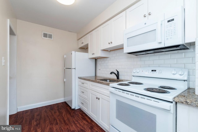 kitchen with tasteful backsplash, white appliances, sink, and white cabinets