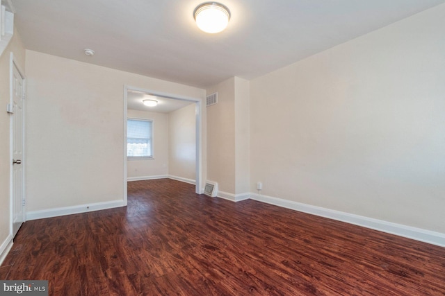 spare room with dark wood-type flooring