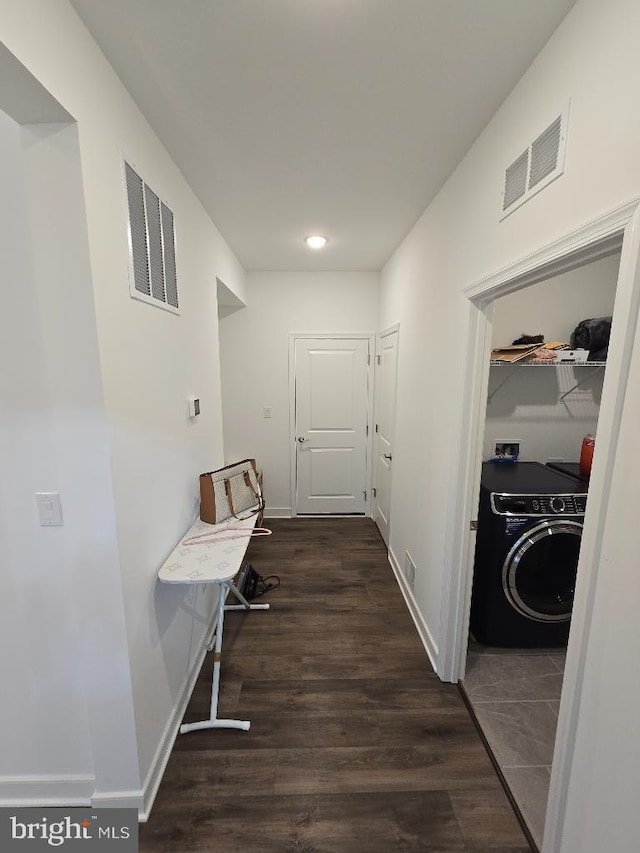 hallway with dark hardwood / wood-style flooring and washer / clothes dryer