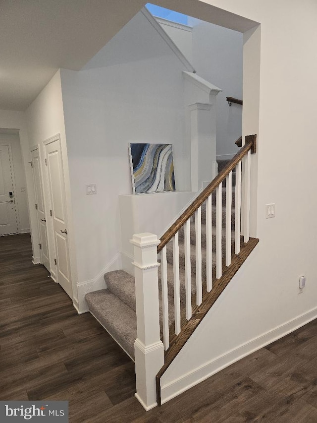 stairs featuring hardwood / wood-style flooring