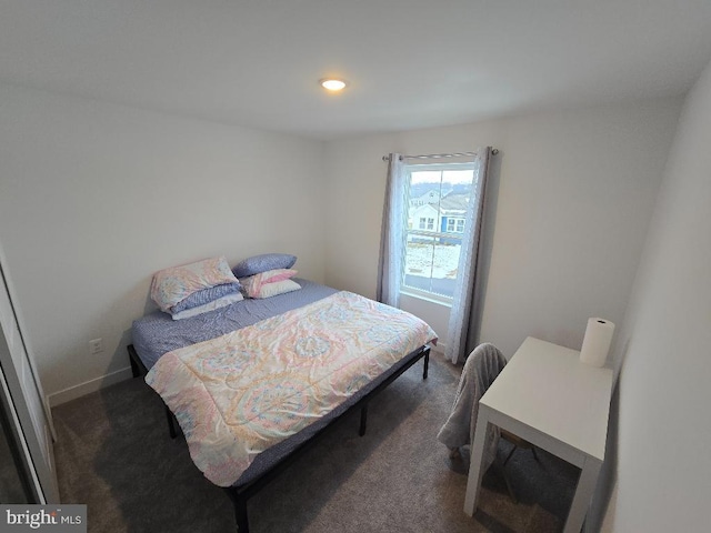 bedroom featuring dark carpet