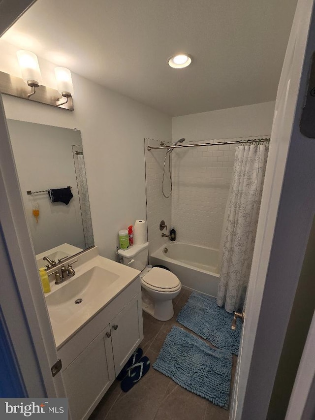 full bathroom featuring vanity, tile patterned floors, shower / bath combo with shower curtain, and toilet