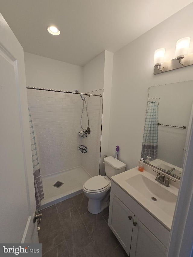 bathroom with vanity, a shower with shower curtain, and toilet