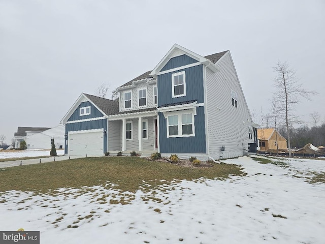 view of front of property with a garage and a yard