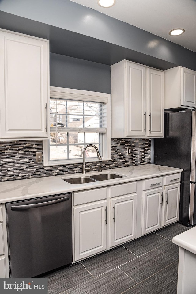 kitchen featuring stainless steel appliances, sink, white cabinets, and decorative backsplash