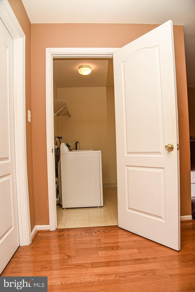 washroom with washer / clothes dryer and light hardwood / wood-style floors