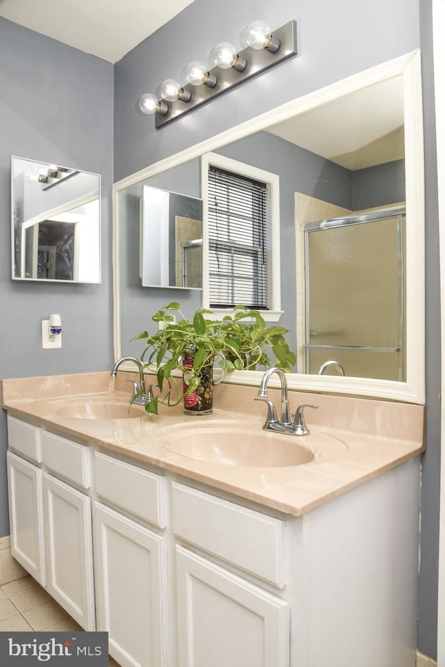 bathroom featuring vanity, an enclosed shower, and tile patterned flooring