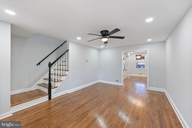 unfurnished living room featuring wood-type flooring and ceiling fan