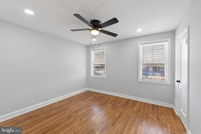 empty room featuring hardwood / wood-style floors and ceiling fan