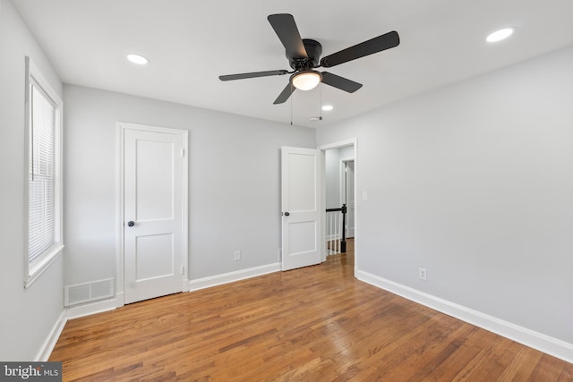 unfurnished bedroom featuring hardwood / wood-style flooring and ceiling fan