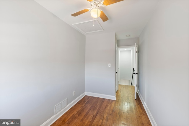 spare room with dark hardwood / wood-style flooring and ceiling fan