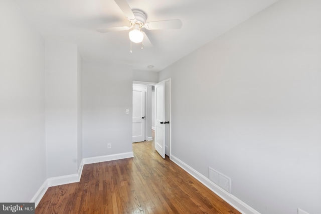 spare room with ceiling fan and wood-type flooring