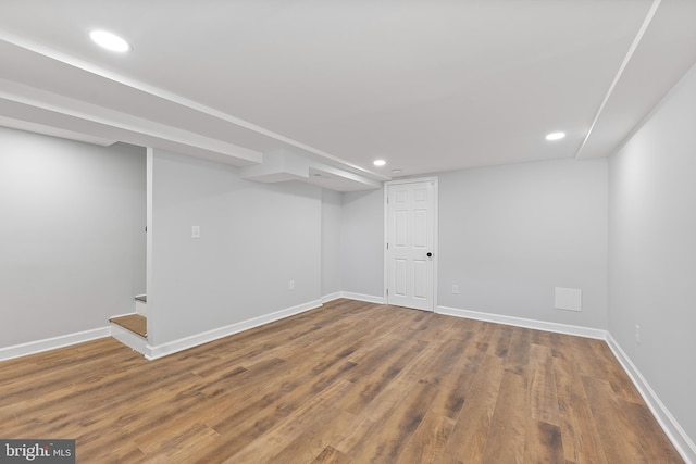 basement with hardwood / wood-style floors