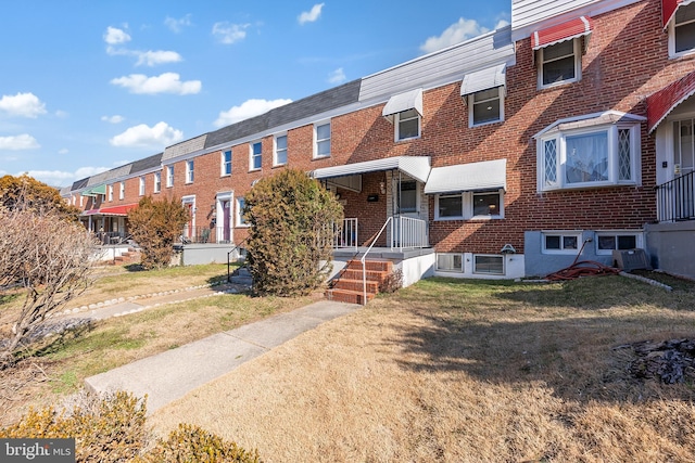 view of property featuring a front lawn